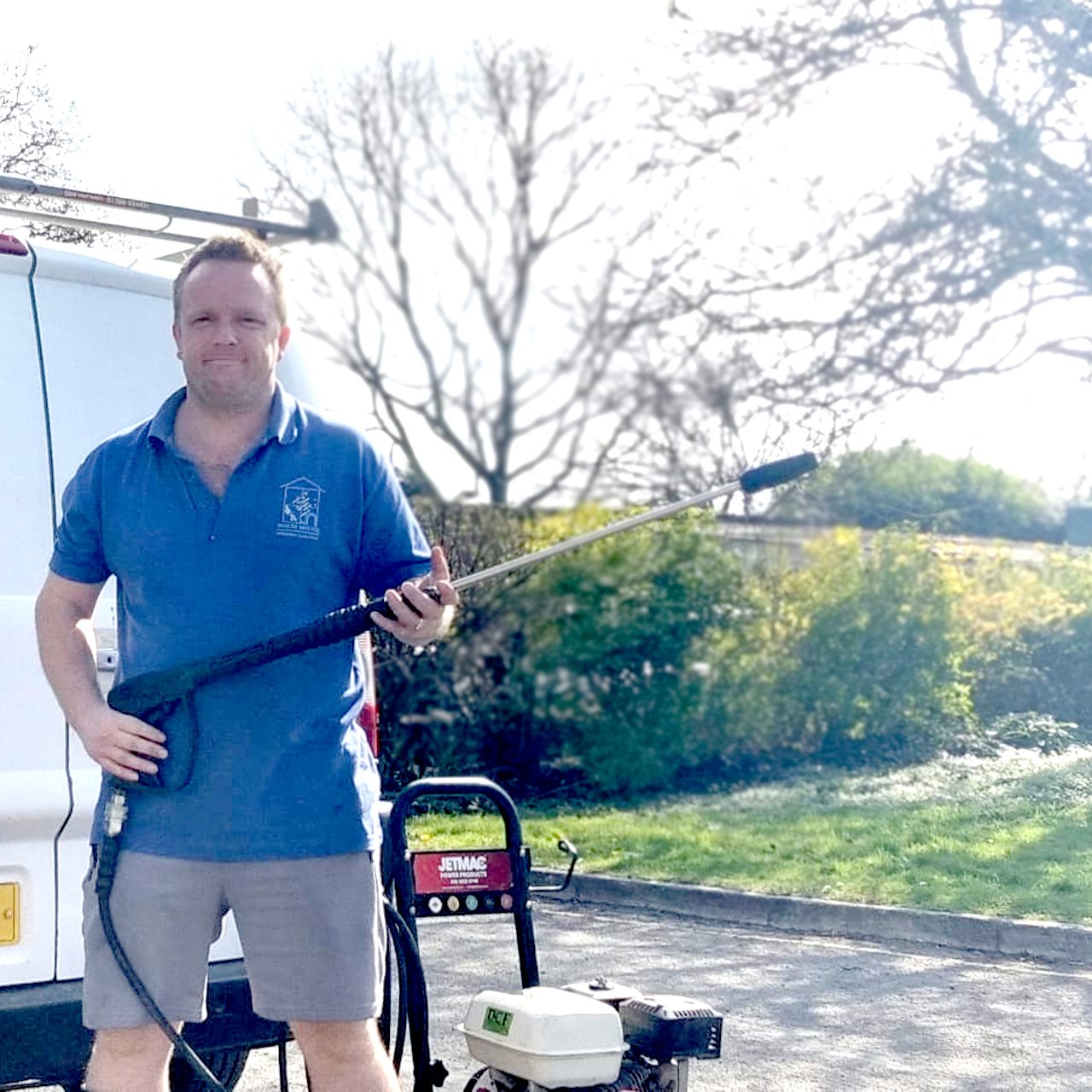 About Us 9 an image of a guy holding a pressure washer