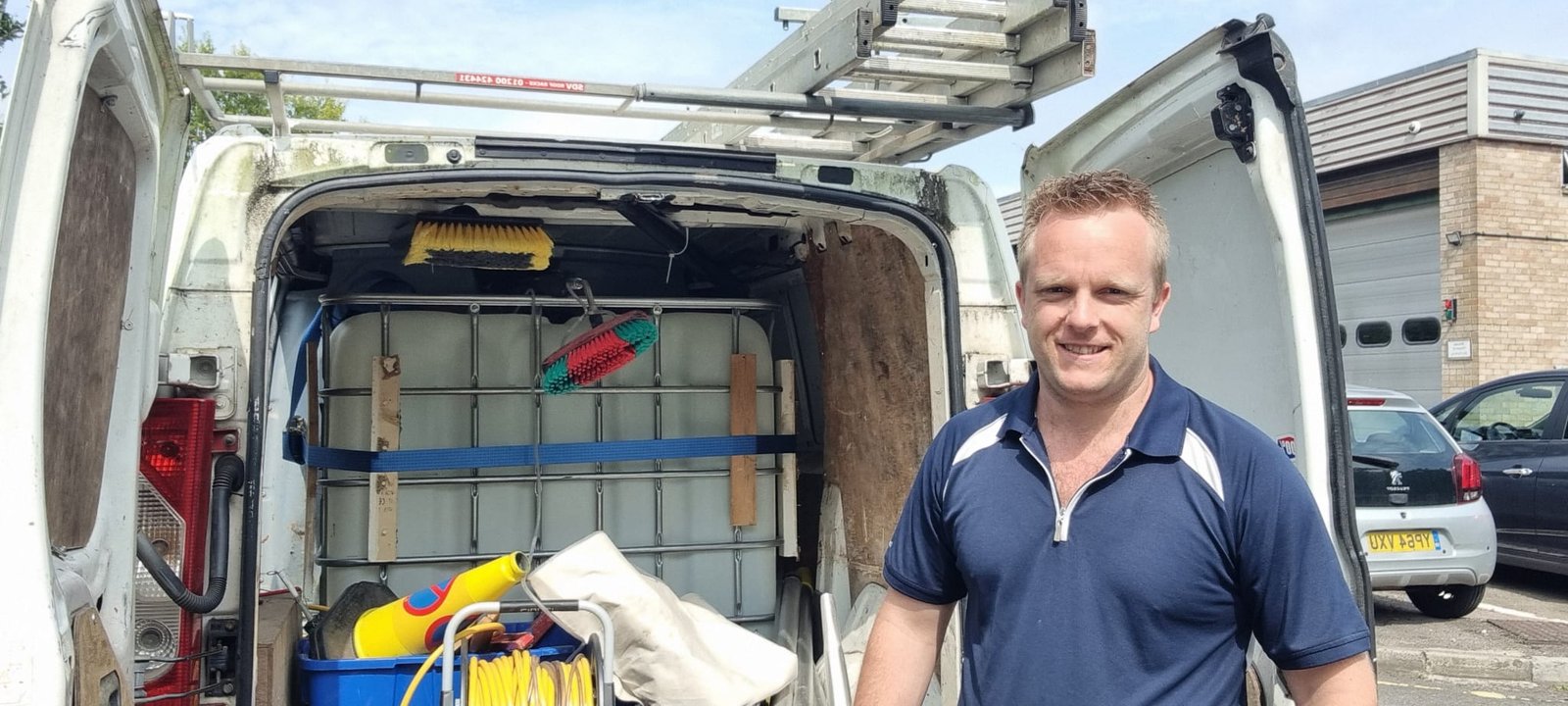 About Us 4 An image of a guy and the back of his van containing window and gutter equipments.