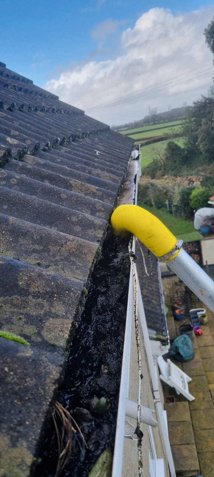 An image of a gutter vacuum clearing a residential gutter in Bristol