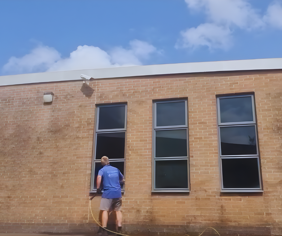 An image of a window cleaner cleaning Elm Parl Leisure Centre in Filton